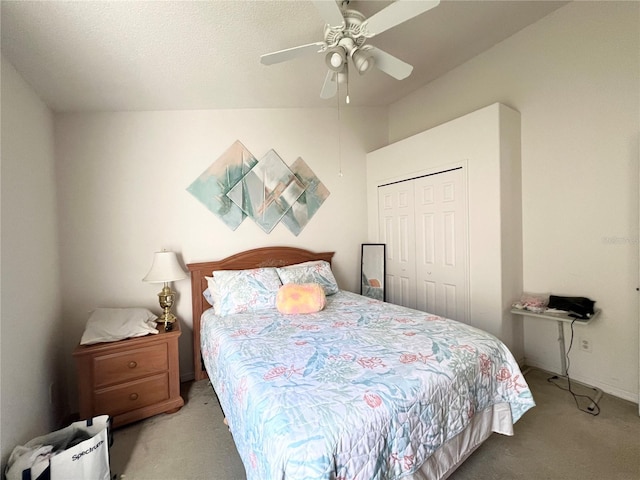 carpeted bedroom with ceiling fan and a closet