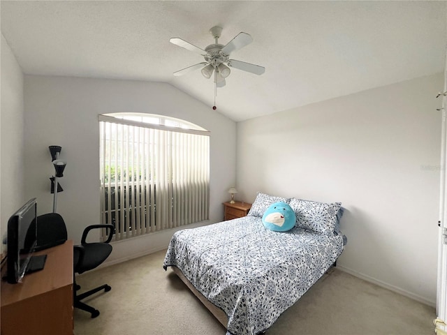 bedroom featuring ceiling fan, light colored carpet, and vaulted ceiling