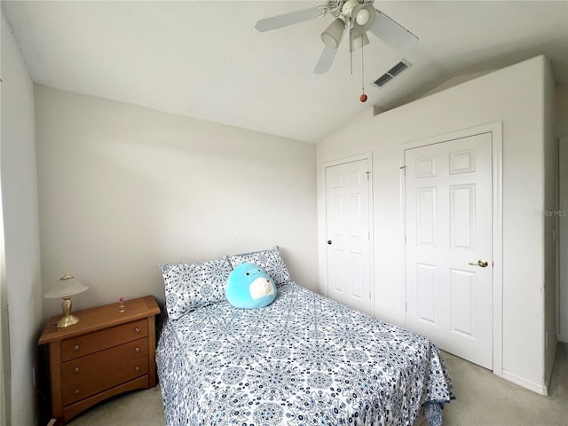 bedroom featuring ceiling fan, light carpet, and lofted ceiling