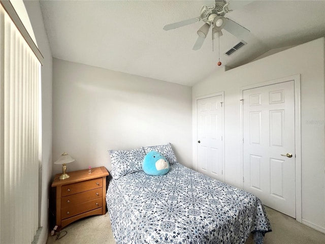 bedroom with ceiling fan, light carpet, and lofted ceiling