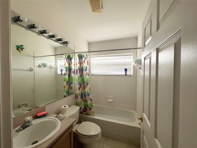 full bathroom with vanity, shower / bath combo, and toilet