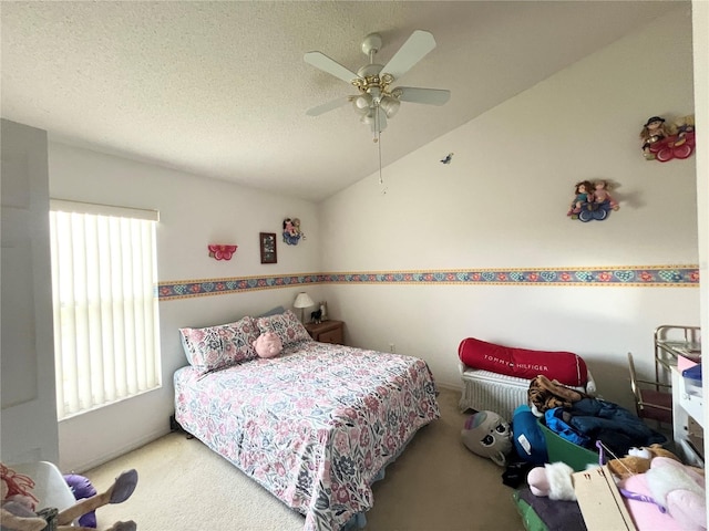 carpeted bedroom with a textured ceiling, ceiling fan, and vaulted ceiling