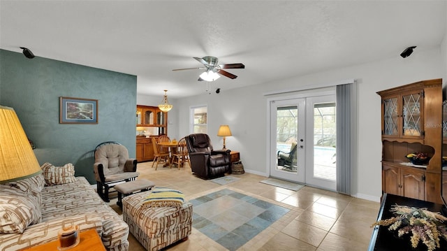 living room with ceiling fan and french doors