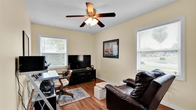 office with hardwood / wood-style floors and ceiling fan