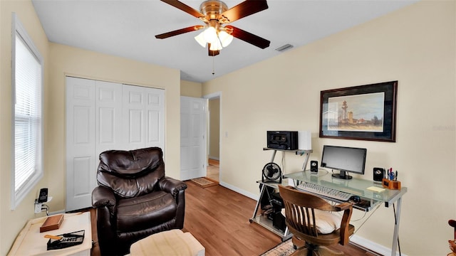 office with ceiling fan and light wood-type flooring