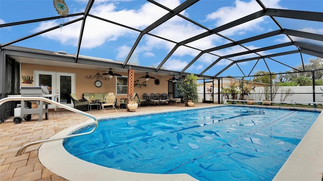 view of swimming pool with french doors, a lanai, outdoor lounge area, ceiling fan, and a patio