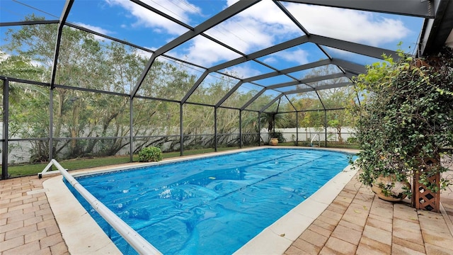 view of pool featuring a patio and glass enclosure