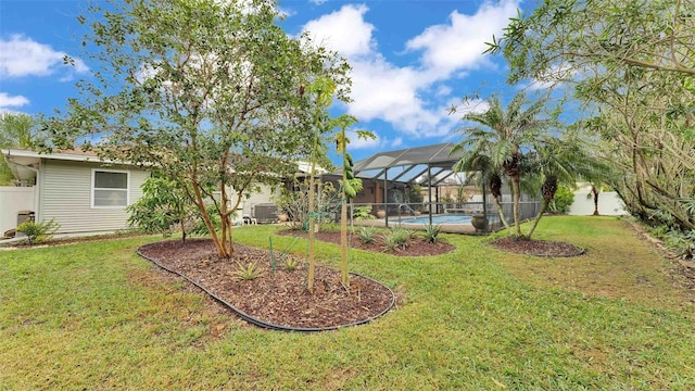 view of yard with glass enclosure, a fenced in pool, and central air condition unit