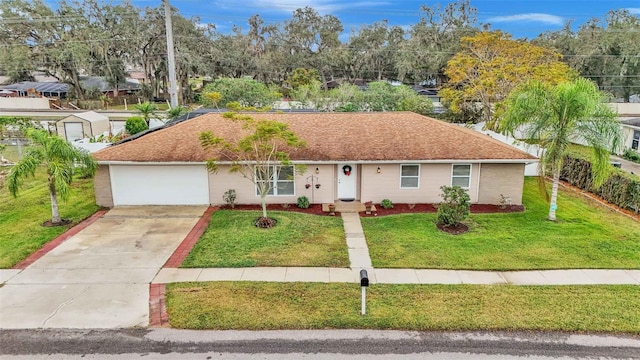 view of front of property with a garage and a front lawn