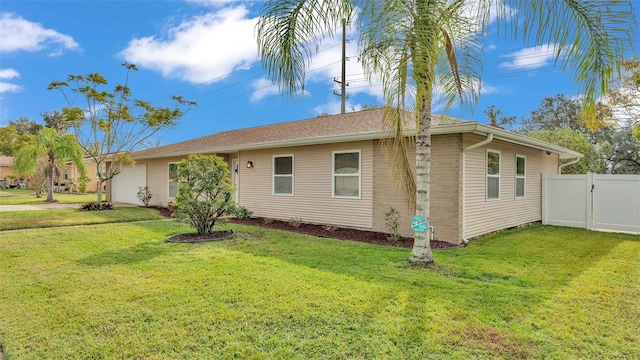 view of side of property with a yard