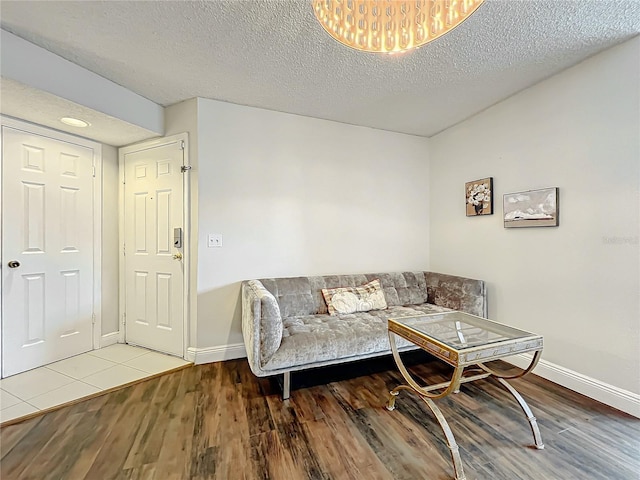 living room featuring a textured ceiling and light wood-type flooring