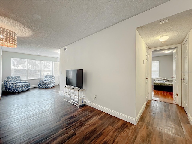 living room with hardwood / wood-style floors and a textured ceiling