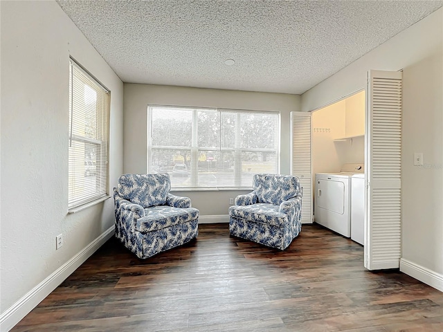 sitting room featuring washing machine and dryer, dark hardwood / wood-style floors, and a textured ceiling