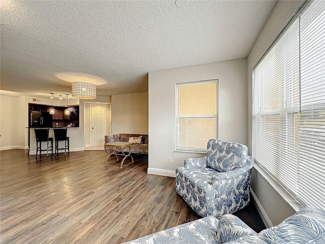 sitting room featuring a textured ceiling and dark hardwood / wood-style flooring