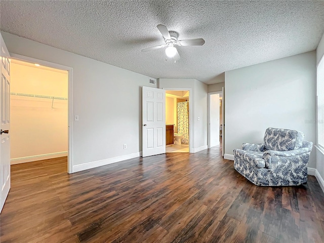 unfurnished room featuring a textured ceiling, ceiling fan, and dark hardwood / wood-style floors