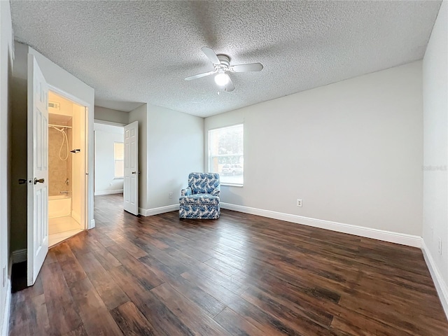 unfurnished room with ceiling fan, dark hardwood / wood-style flooring, and a textured ceiling