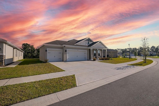 view of front of house with a garage and a lawn