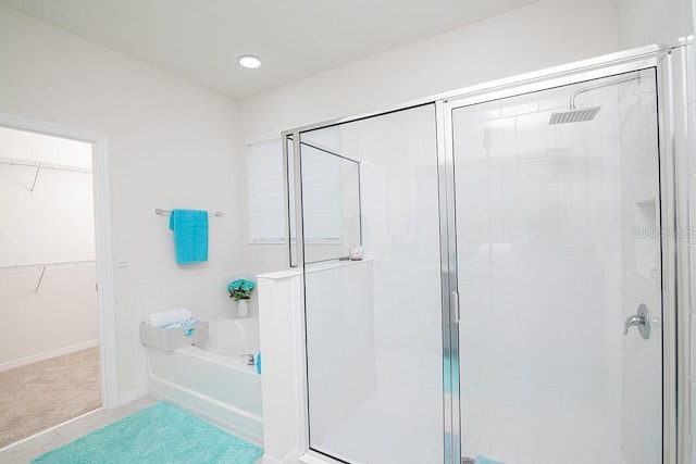 bathroom featuring shower with separate bathtub