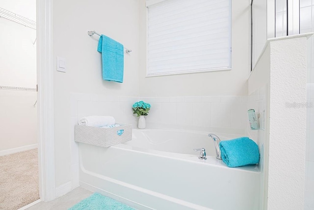 bathroom with a tub to relax in