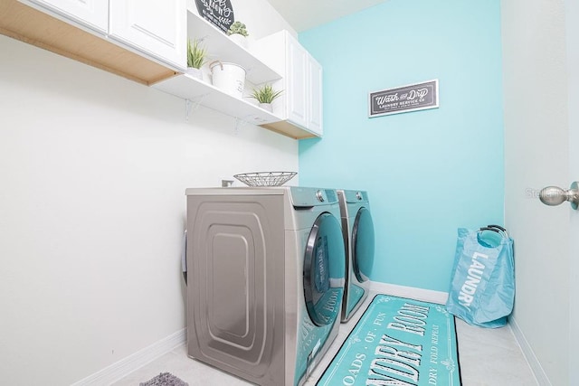 washroom with washer and clothes dryer and cabinets