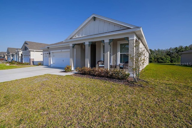 view of front of property with a front lawn, covered porch, and a garage