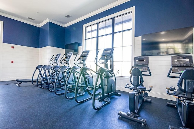 workout area featuring ornamental molding