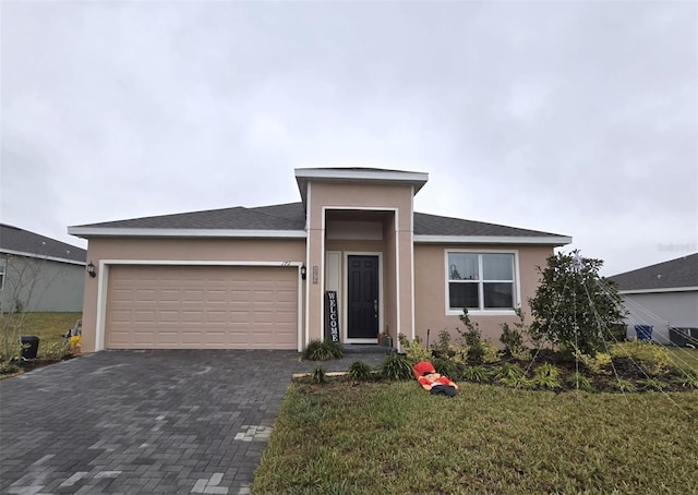 view of front facade with a garage and a front yard