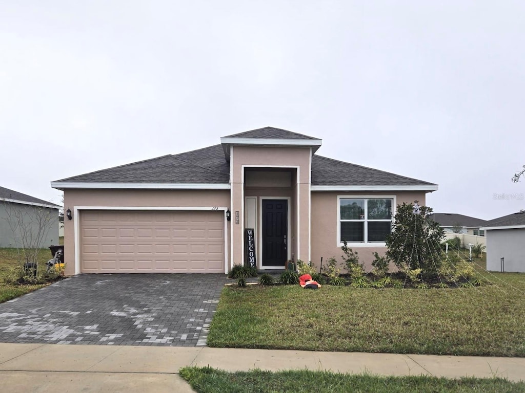 view of front of house with a front lawn and a garage