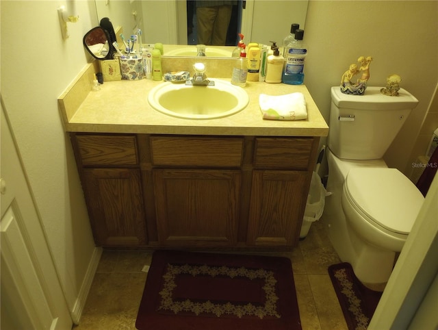 bathroom with tile patterned floors, vanity, and toilet