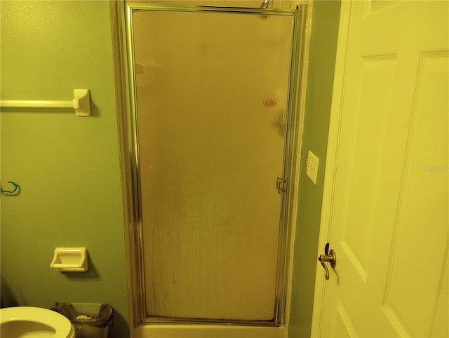 bathroom with a shower with door