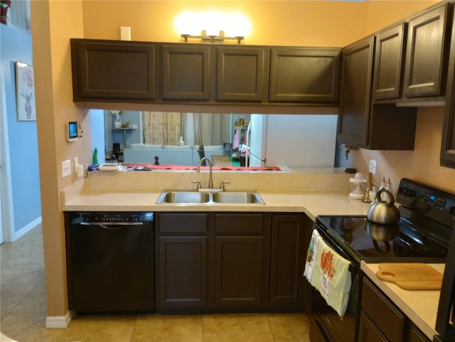 kitchen with light tile patterned floors, sink, dark brown cabinets, and black appliances