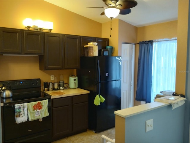 kitchen with dark brown cabinetry, ceiling fan, lofted ceiling, light tile patterned floors, and black appliances