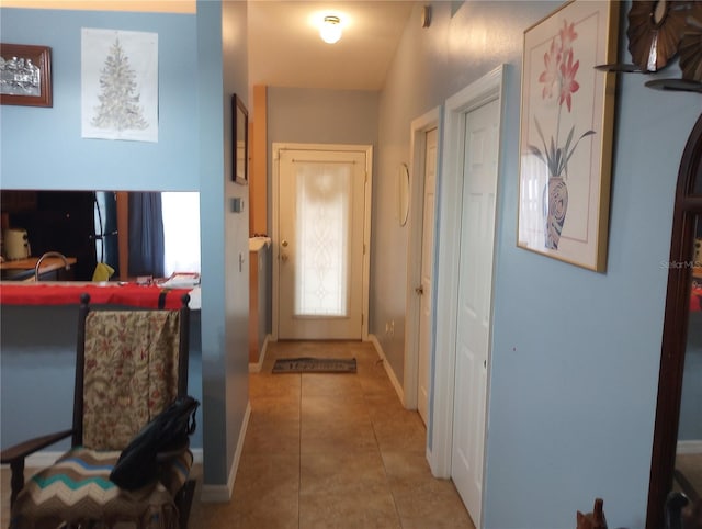 doorway with tile patterned flooring