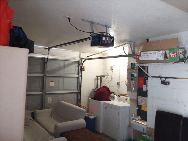 garage featuring independent washer and dryer and a garage door opener