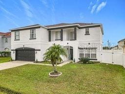 view of front of home featuring a front yard and a garage