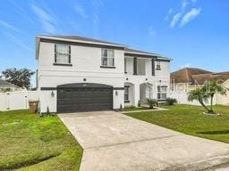 view of front of property featuring a garage and a front yard