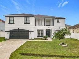 view of front of home featuring a garage and a front yard