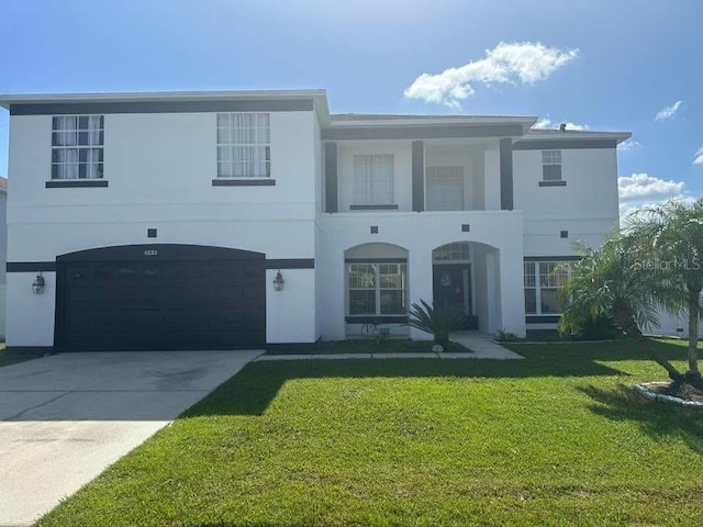 view of front of home with a garage and a front lawn