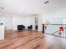 unfurnished room with wood-type flooring