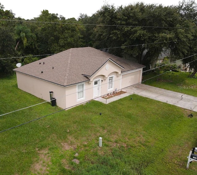 view of front of home with a garage and a front lawn