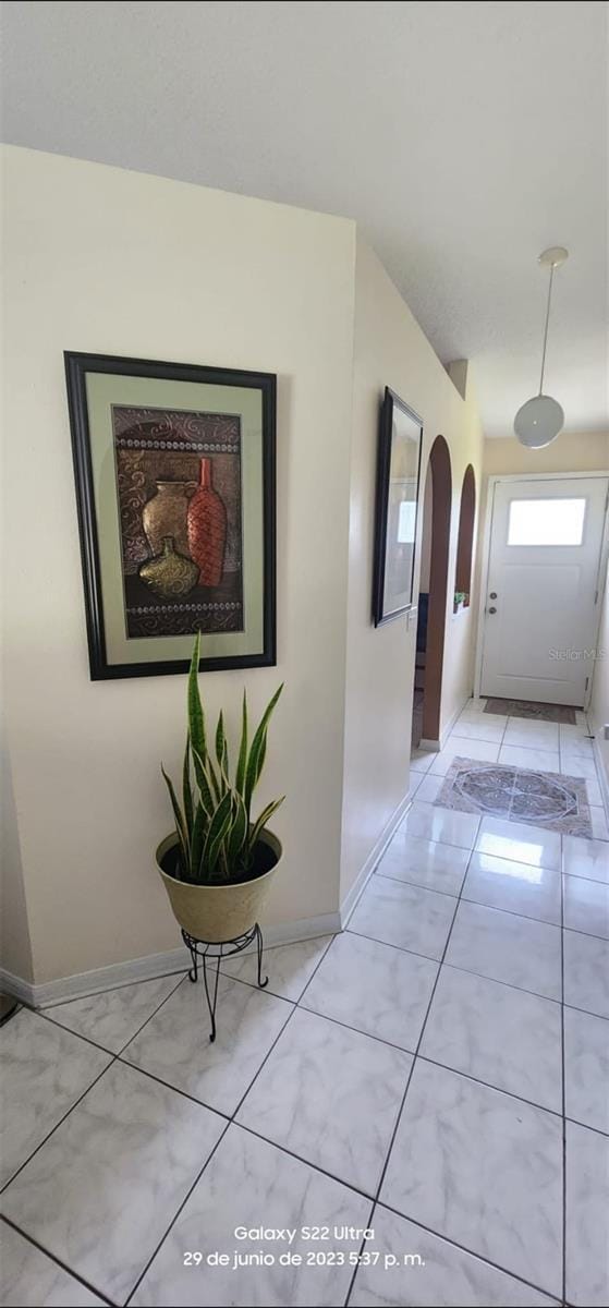 hallway featuring light tile patterned floors