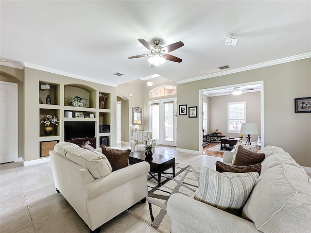 tiled living room featuring built in shelves, ceiling fan, ornamental molding, and french doors