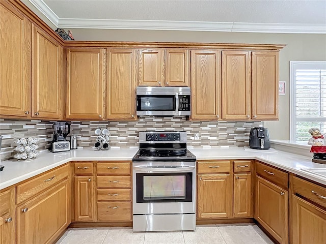 kitchen featuring backsplash, ornamental molding, and stainless steel appliances