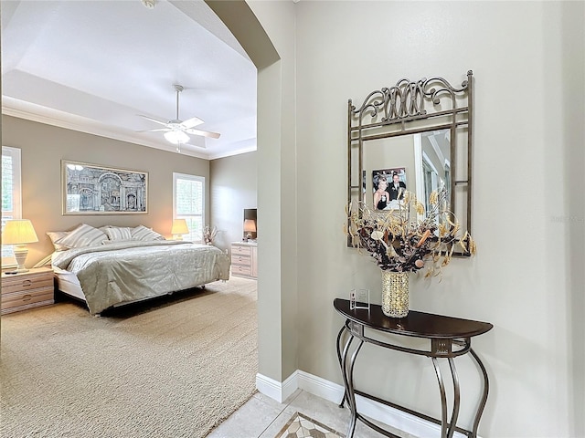 bedroom with ceiling fan, light colored carpet, and ornamental molding