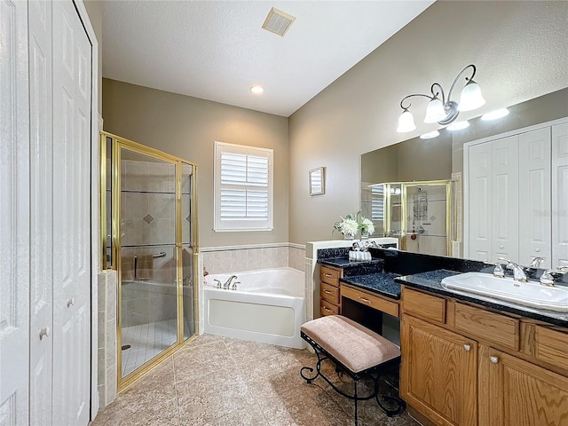 bathroom featuring tile patterned flooring, vanity, and separate shower and tub