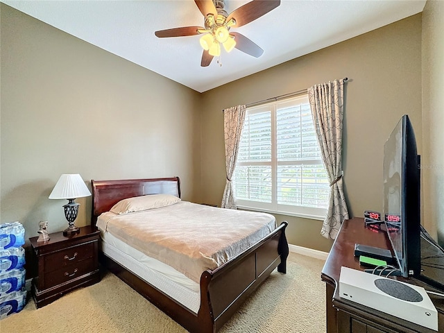 bedroom with ceiling fan and light colored carpet