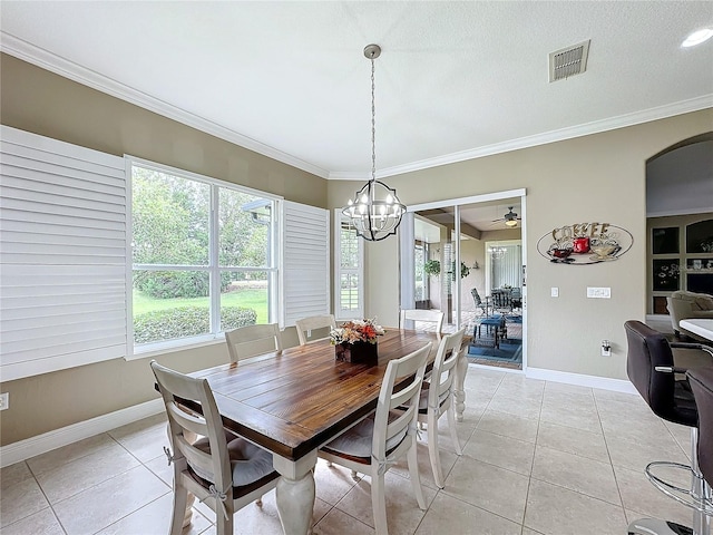 dining room with a textured ceiling, ceiling fan with notable chandelier, light tile patterned floors, and crown molding