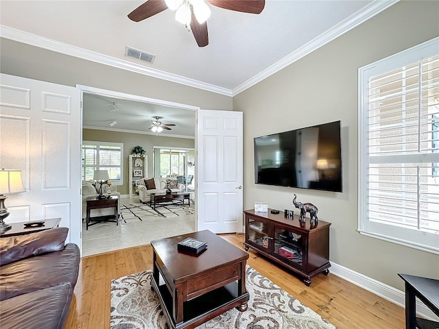 living room featuring light wood-type flooring and crown molding