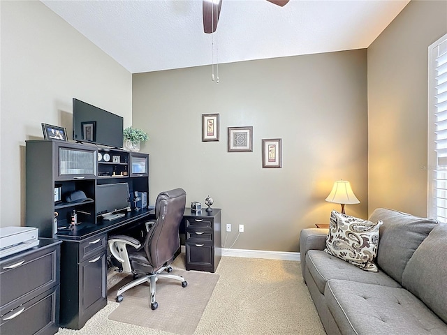 carpeted office with a wealth of natural light and ceiling fan