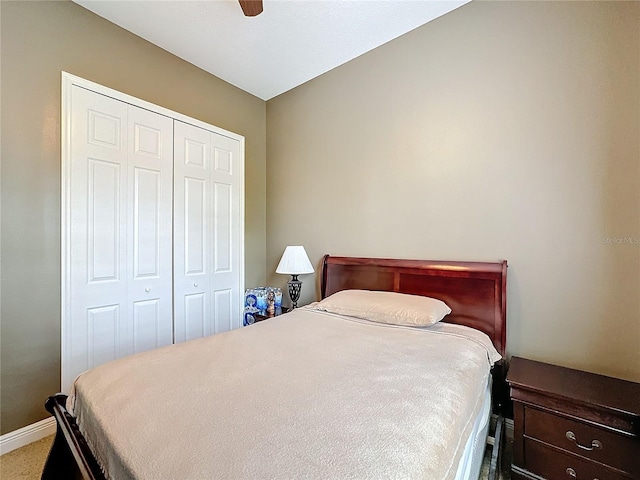 carpeted bedroom featuring ceiling fan and a closet